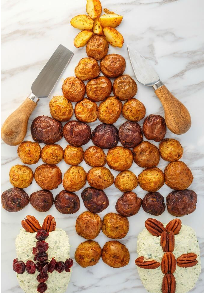 A holiday cheese ball with little potatoes in the shape of a jaunty little Christmas tree.