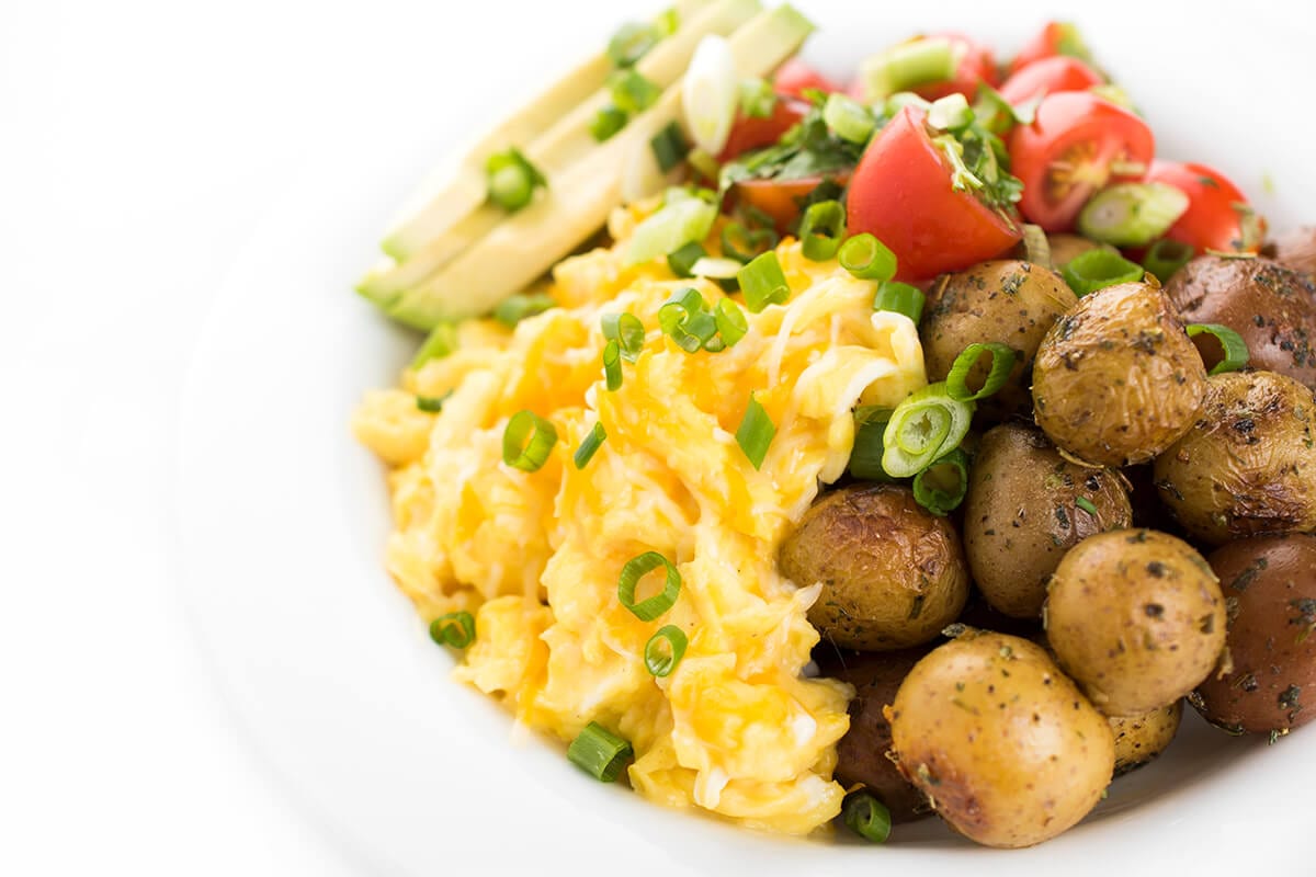 A cheesy egg and potato breakfast bowl.