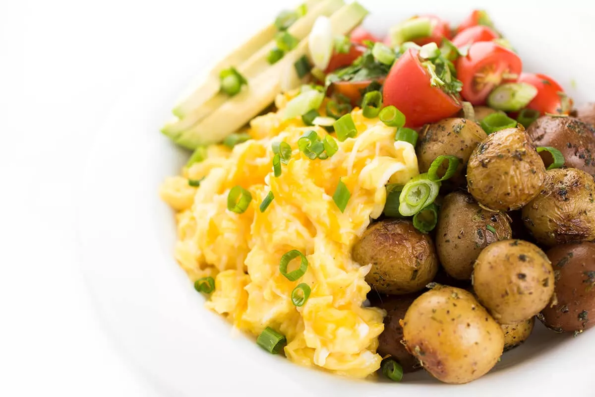 A cheesy egg and potato breakfast bowl.