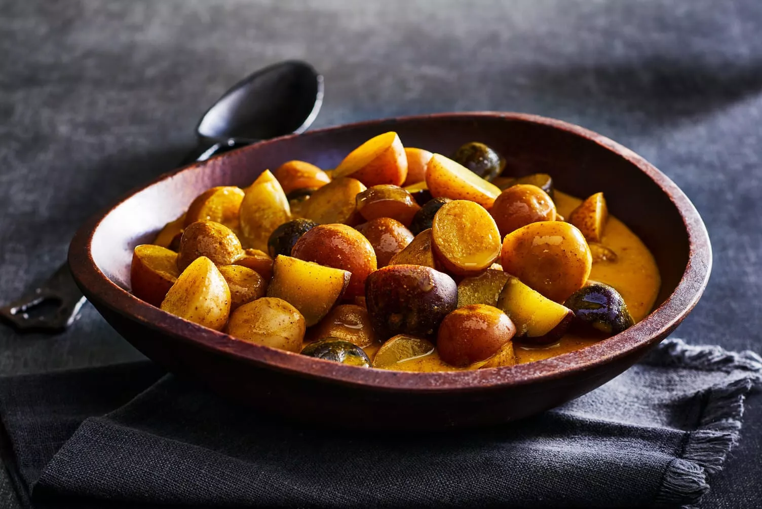 Golden milk poached potatoes in a nice wooden bowl.