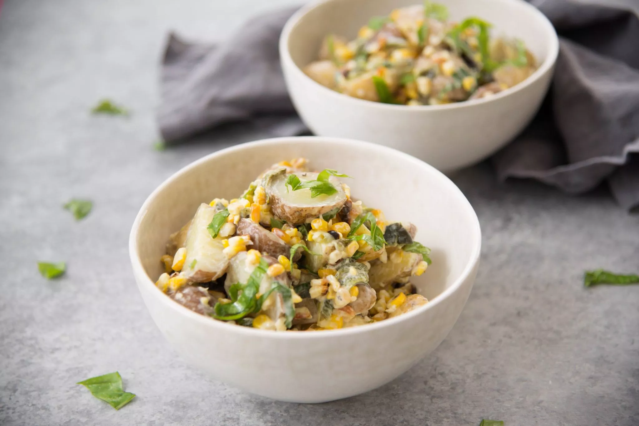 Bowls of grilled corn and poblano potato salads.