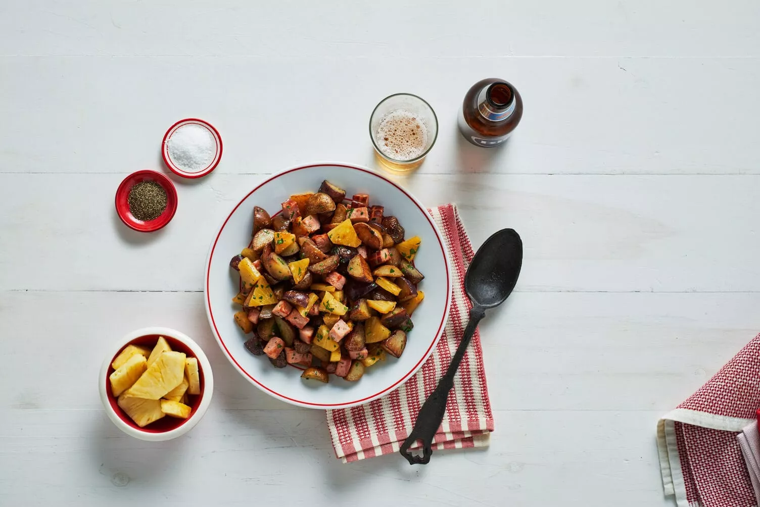 A bowl of ham and pineapple pan-fried potatoes.