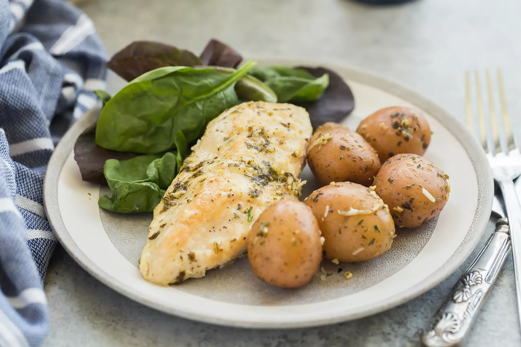 A plate of pesto Parmesan Instant Pot chicken and potatoes.