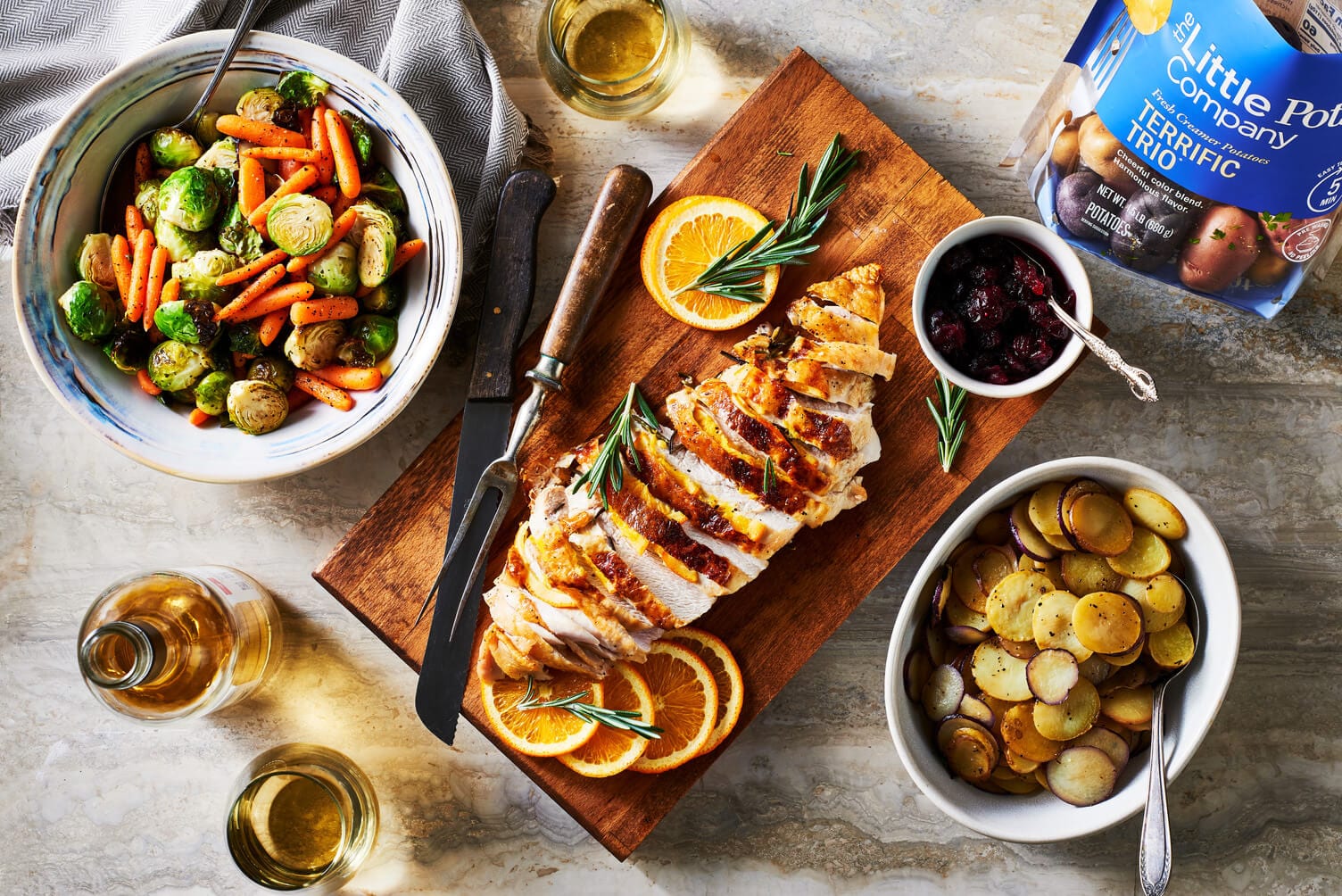A turkey dinner for two with lots of fresh veggies.